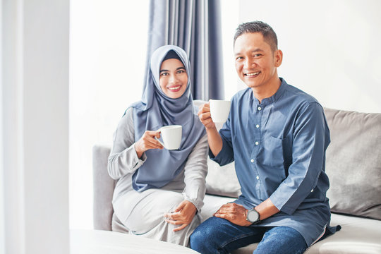 Beautiful Indonesian Muslim Couple Drinking Coffee At Home