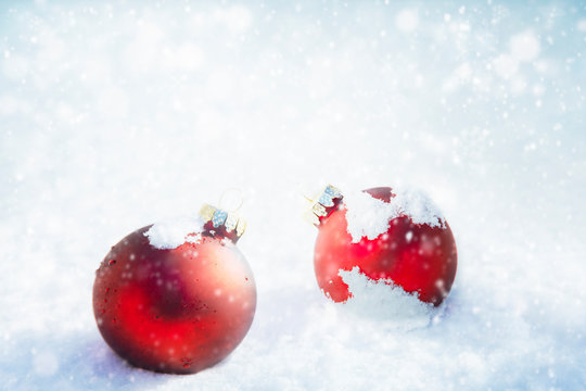 Christmas red ornaments on white snow background