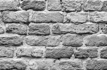 black and white bricks background , texture of an old rough brick wall