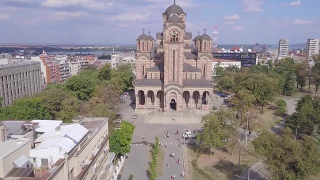 Establishing fantastic 4k shot of St Mark Church and Tasmajdan park in Belgrade, summer day aerial