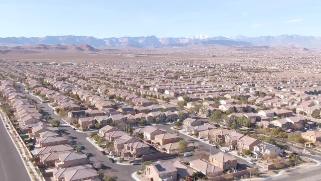 DRONE: Scenic shot of Las Vegas suburbs sprawling across the Mojave desert. Real estate properties fill up the arid terrain leading up to the city of Las Vegas. Stunning shot of American suburbia