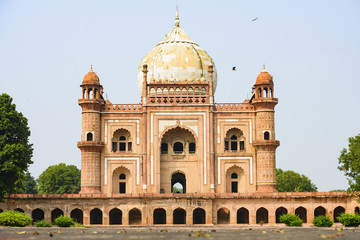 Fototapeta na wymiar Stunning view of the Safdarjung Tomb with its domed and arched red brown and white coloured structures. Safdarjing is a sandstone and marble mausoleum in New Delhi, India.