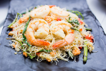 Thai Cuisine, Stir-fried rice vermicelli and water mimosa with prawns on black plate