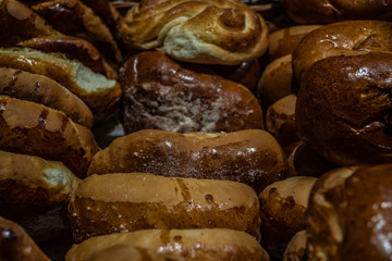 Various breads sitting on a large shelf stock photo