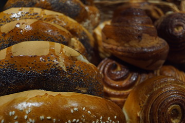 Various breads sitting on a large shelf stock photo