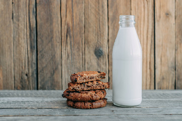 milk and cookies on a wooden table