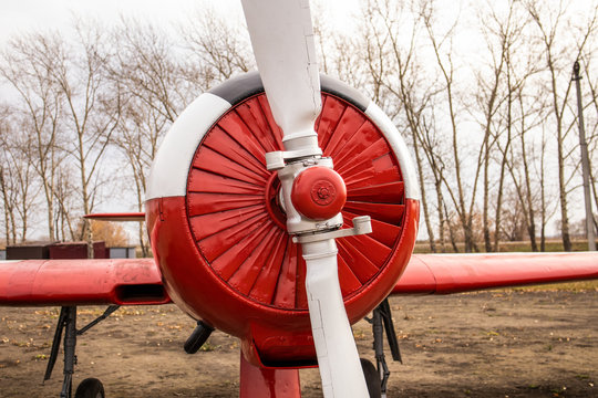 Big white propellers of an old red airplane. Twin-seat engine