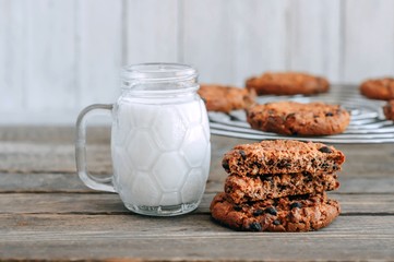 milk and cookies on a wooden table