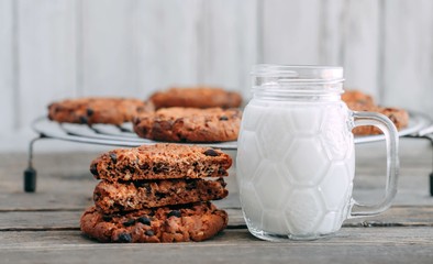 milk and cookies on a wooden table