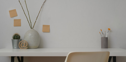 Minimal workspace with copy space ,office supplies and decorations with white wall