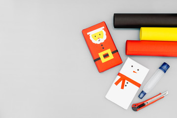 Christmas DIY background concept . Top view of DIY snowman and santa claus gift boxes with copy space. Celebration of winter holidays concept