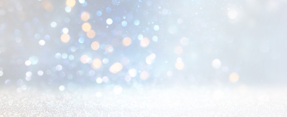 Obraz premium abstract glitter silver, gold , blue lights background. de-focused. banner