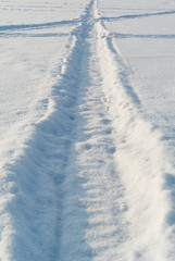 Tracks on winter snow field