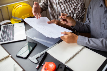 Team Engineer and Architect Joint consult manager project work.blueprint  at Construction Site with new startup in Office.