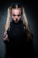 Halloween clown woman portrait posing over concrete wall background