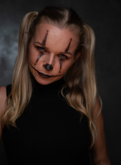 Halloween clown woman portrait posing over concrete wall background