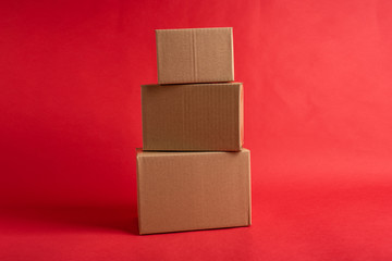 Bunch of blank courier box paper boxes on red background
