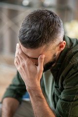 Man having headache while waiting for psychoanalyst