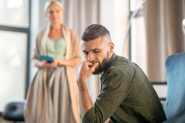 Businessman feeling confused while coming to psychologist