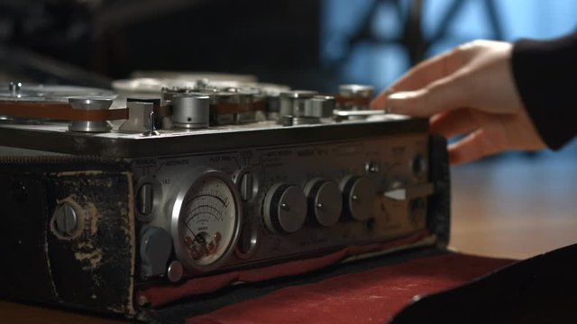 Start playback of vintage sound tape reel recorder in archive room