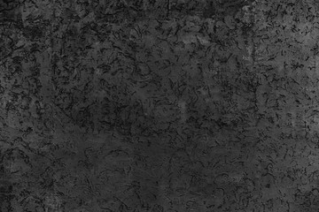 Rough dark relief stucco wall texture background. blank for designers