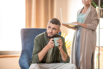 Bearded man feeling thoughtful while visiting psychoanalyst