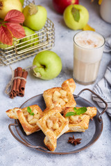 Delicious puff pastries with apples, plums and cinnamon. Sweet autumn dessert.