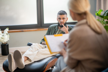 Man sitting on comfy armchair and sharing his thoughts