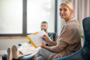 Blonde-haired experienced psychoanalyst working all day long