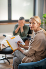 Pleasant psychoanalyst feeling good while helping client