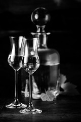 Grappa served in two glasses in black and white