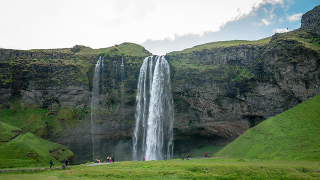 Gljufrabui waterfall with unidentifed tourists nearby in Iceland
