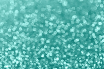 Abstract shiny mint color background. Bokeh and sparkles. Selective focus, bokeh. Christmas background