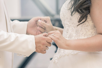 Hands of bride and groom with rings