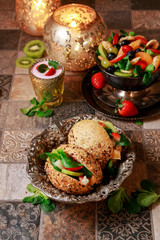 Vege burger bun with vegetables and fruits.