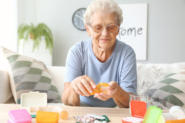 Elderly woman with medicines at home