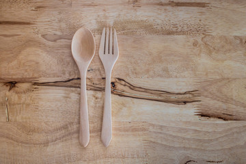 spoon and fork on wooden background