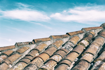 outdoor view of an old tiled roof with desaturated sky