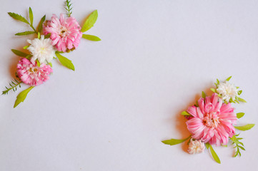 Beautiful light tender floral arrangement with pink and white flowers and green leaves. Flat lay, copy space, top view