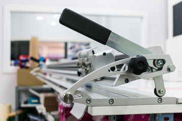 Detail closeup of paper cutter machine mechanism