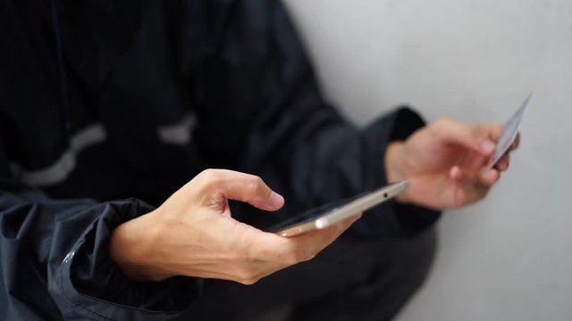 man holding credit card and using smartphone. Cyber crime concept, Data thief, internet attack, darknet and cyber security concept.