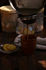 poring tea in a clay cup