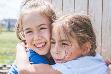 Fototapeta premium Tender sincere hugs of sisters. Family relationships.