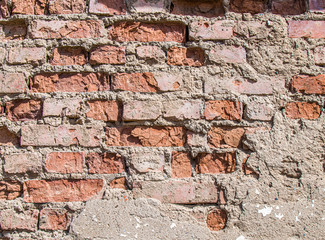 Wall of old weathered brick as a background