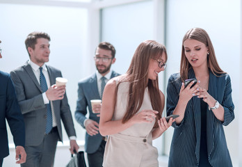 young employees exchanging information in the office lobby