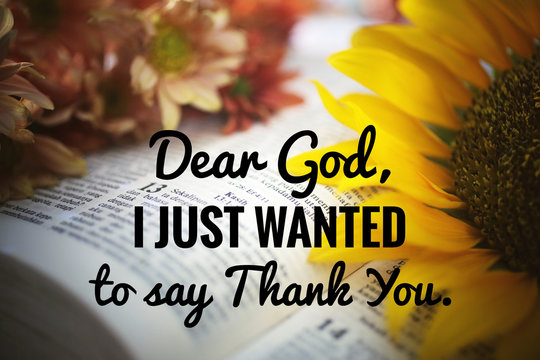 inspirational quote - Dear God, i just wanted to say thank you. With blurry background of holy bible book open and flowers blossom