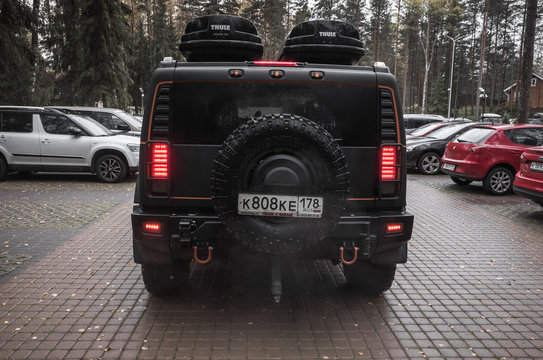Black Hummer H2 stands on parking, rear view