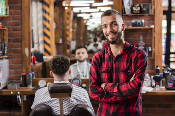 Young hairdresser with shirt smiling satisfied