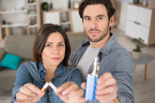 man and woman breaking cigarette quitting smoke