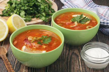 Two bowls with traditional Russian soup solyanka	
